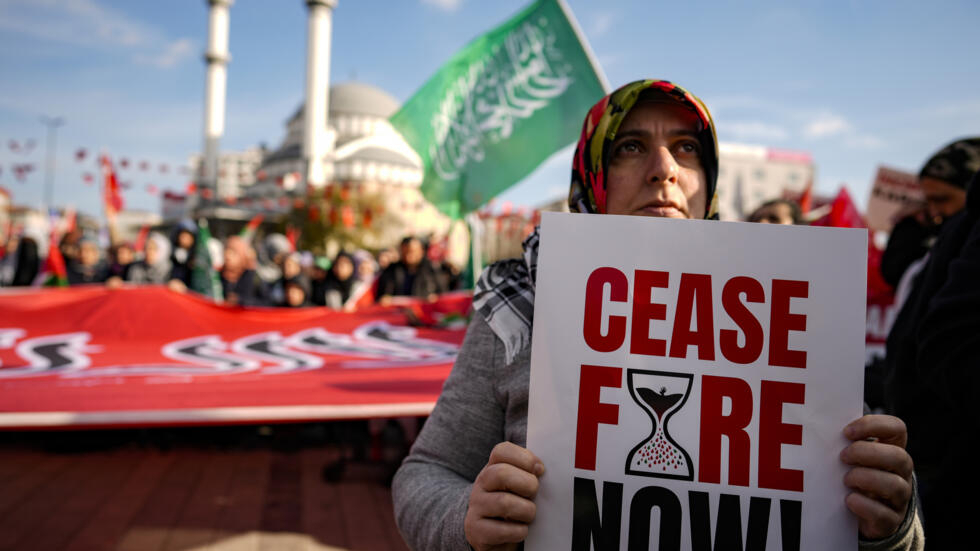 A woman holds a placard during a protest in Istanbul, Turkey, calling for an immediate ceasefire in Gaza, on 14 January 2024. 