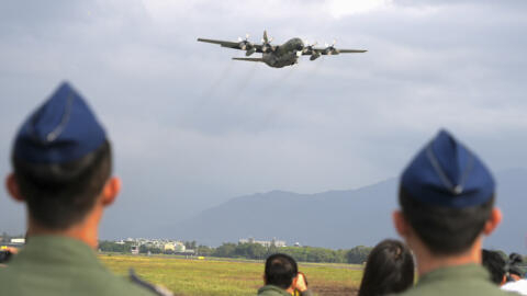 A C130 transport plane flies near an airbase in southern Taiwan's Pingtung county on Tuesday, Jan. 30, 2024.