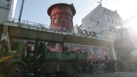 Workers work to secure the area in front of the theatre after the blades of the Moulin Rouge windmill collapsed on 25 April, 2024.