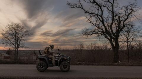 A Ukrainian soldier drives a quad bike on a road that leads to the town of Chasiv Yar, in the Donetsk region, on 30 March, 2024.