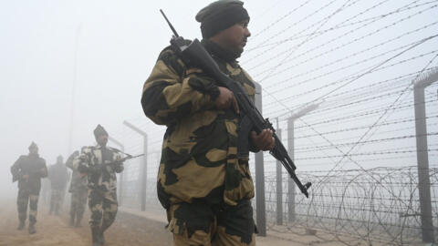 Indian border security forces patrol the barrier between India and Pakistan at Wagah, about 40km from Amritsar, on 21 December 2022.