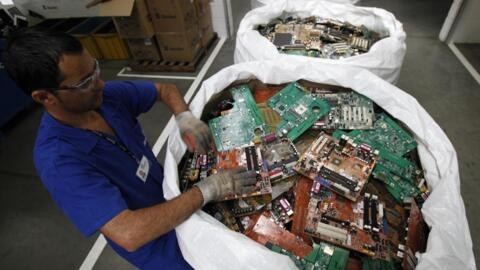 An employee selects parts of discarded computers in the recycling department of Itautec SA, in Jundiai, Brazil. 