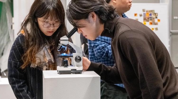 man looking into a microscope