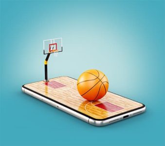 An image featuring a phone that has a basketball hoop and a basketball on top of it