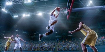 An image featuring a person dunking on a basketball match