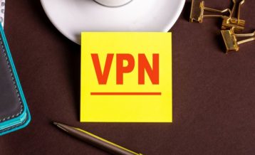 an image with pens in the background as well as clippers and a yellow note in the middle which says VPN in red