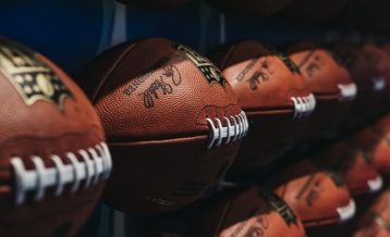 an image of a bunch of footballs on a rack