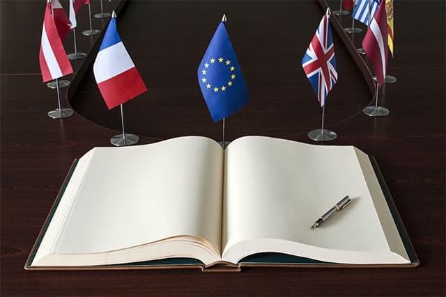 An image featuring a open book with European flags in the background representing the Europe commission report