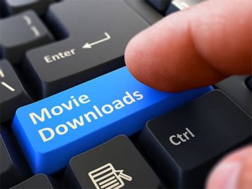 An image featuring a person pressing the shift button that is replaced with the text movie downloads representing downloading movies