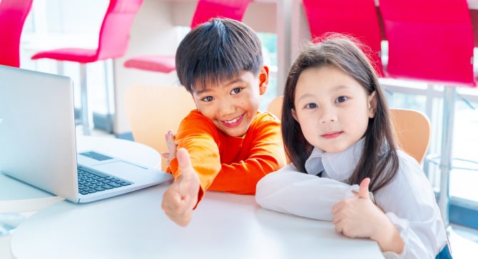 Asian Children Using laptop at international school