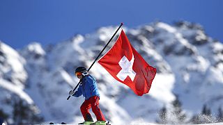 A young Swiss supporter hold a Swiss banner prior to the start of alpine ski, women's World Cup giant slalom, in Lenzerheide, Switzerland, Saturday, Jan. 27, 2018.