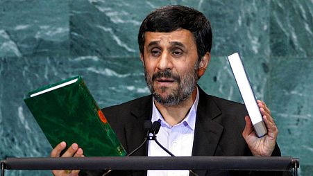 Sept. 23, 2010 file photo, Mahmoud Ahmadinejad, President of Iran, holds up a copies of the Quran, left, and Bible, right, as he addresses the 65th session of the UN