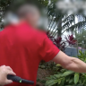 Queensland Police officers search people with metal detection wands under an earlier trial of the increased powers in Gold Coast party precincts.