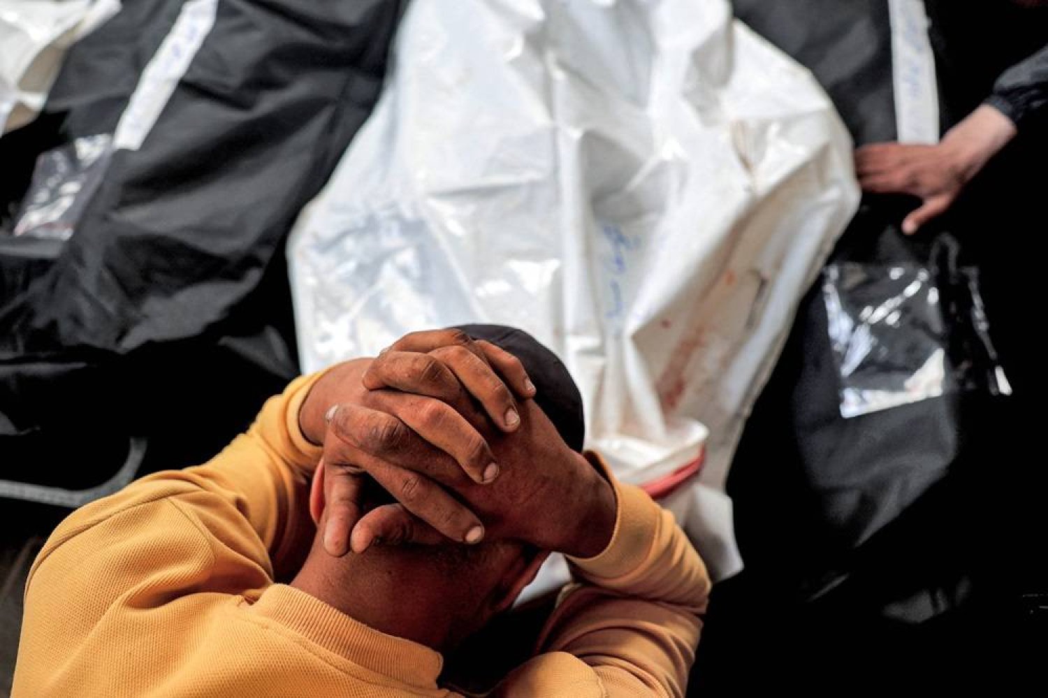 A man mourns over the bodies of relatives who were killed the previous night during Israeli bombardment, at Al-Najjar hospital in Rafah in the southern Gaza Strip on April 16, 2024 amid the ongoing conflict in the Palestinian territory between Israel and Hamas. (AFP) 