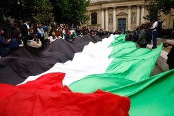Pro-Palestinian demonstrators carry a huge Palestinian flag as they gather outside the Sorbonne University, where they tried to set up a protest camp before being evacuated by police in Paris, France, 29 April 2024. (EPA) 