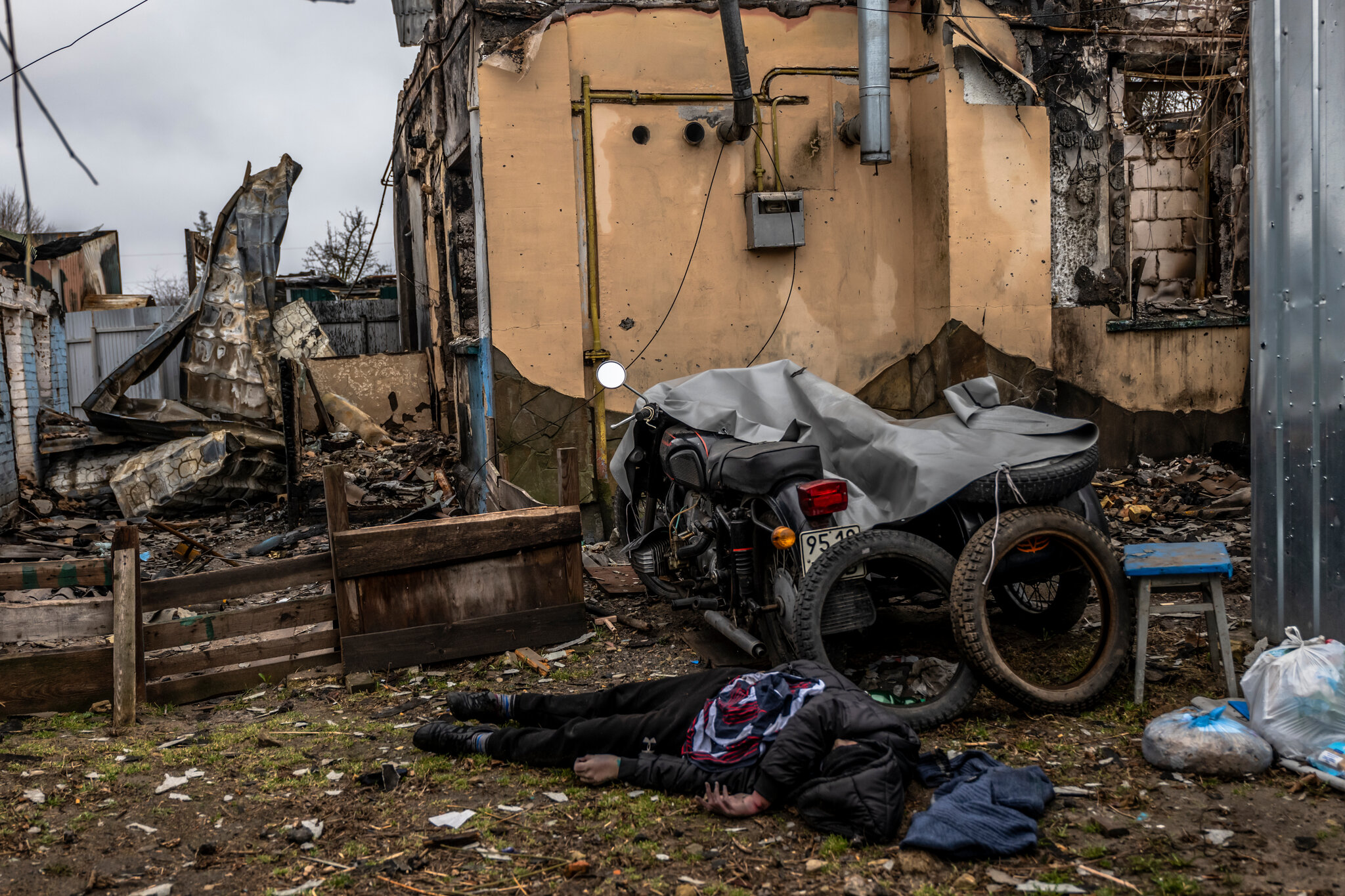 The body of a civilian in the yard of a destroyed home on Yablunska Street.