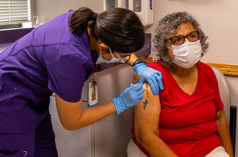 A woman receiving a fourth shot in September in Phoenix. While a Covid infection can be a matter of inconvenience for some, it can spell severe disease, hospitalization and death for older adults and immunocompromised people.