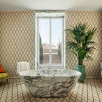 A single block of Arabescato Corchia marble was used to carve the free-standing bathtub in the 3,200-square-foot Bulgari Suite at Rome’s new Bulgari Hotel.