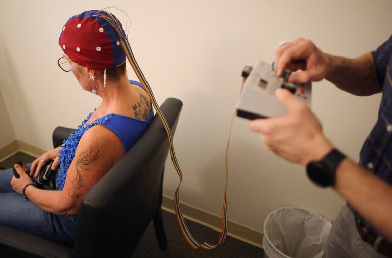 A long Covid patient with cognitive challenges prepared for a neurofeedback therapy session in Massachusetts in June.