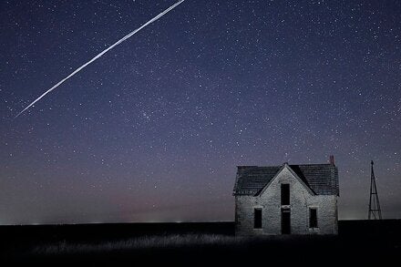 In this long exposure, a string of SpaceX Starlink satellites passed over an old stone house in 2021 near Florence, Kan.