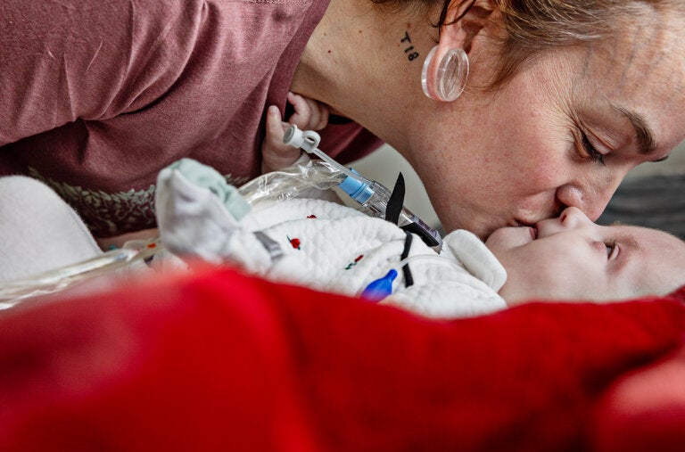Ashlee Wiseman with her daughter, Lennie Cardwell-Risenmay, who was born with trisomy 18, at home in Midvale, Utah. 