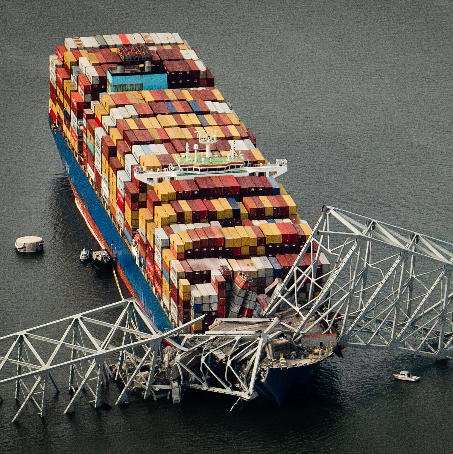 A photo shows the cargo ship with the collapsed bridge.