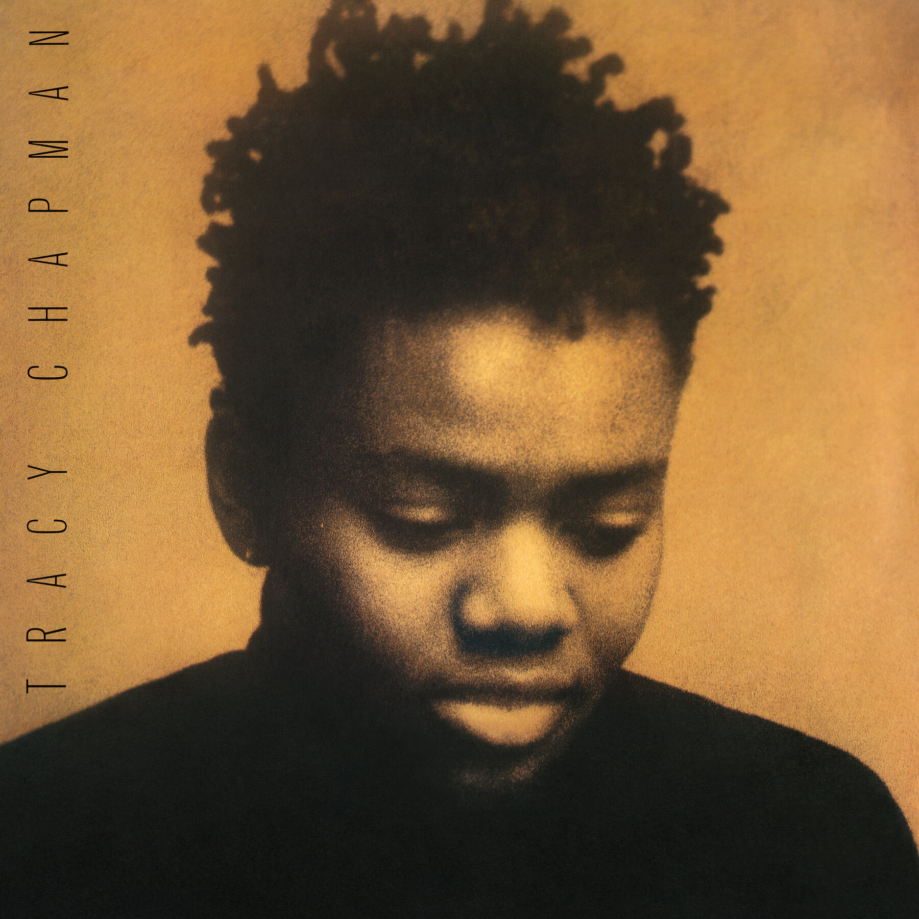 A sepia-toned album cover, with the title "Tracy Chapman" rotated to the side, running vertically on the left side, and a portrait of Chapman looking down.