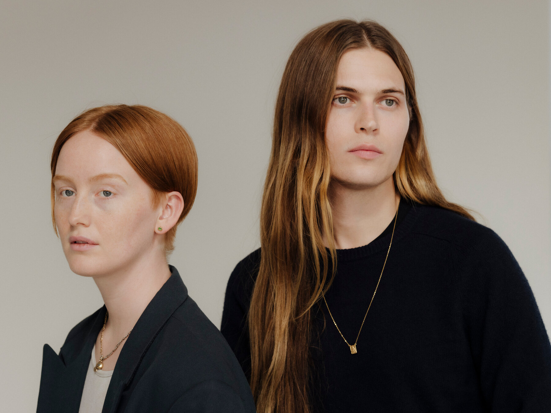 A portrait of Bobbi Salvör Menuez and Michael Bailey-Gates against a gray background.