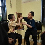 Aiden Diaz, left, passed the drum to his brother JoAngel during music therapy at a Brooklyn homeless shelter.