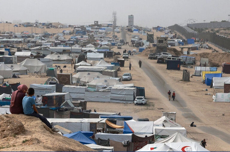 Displaced Palestinians on a dune overlooking their tent camp in Rafah. Israel was weighing whether to proceed with an invasion of Rafah, Hamas’s final stronghold in the Gaza Strip.