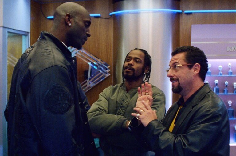 From left, Kevin Garnett and LaKeith Stanfield listen to Adam Sandler’s pitch in “Uncut Gems.”