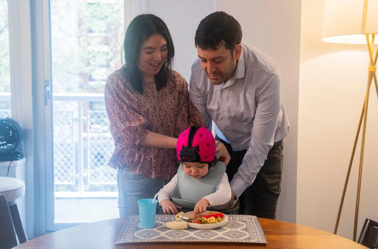 For an hour each week for the past 11 months, Brenden Lake, right, a psychologist at New York University, with his wife Tammy Kwan, has been attaching a camera to their daughter Luna and recording things from her point of view.