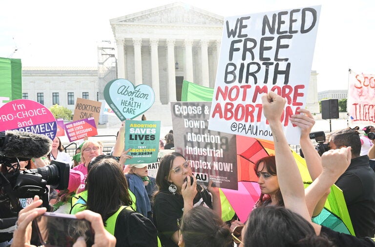 Protesters outside the U.S. Supreme Court. The court’s ruling could extend to at least half a dozen other states that have similarly restrictive bans, and the implications of the case could stretch beyond abortion.