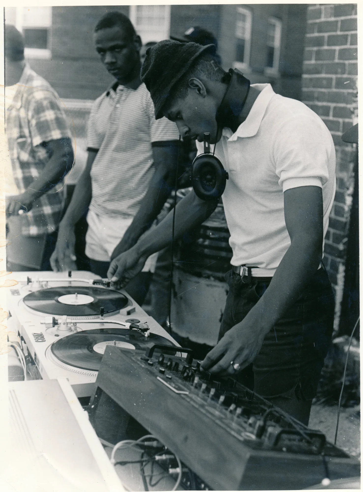 people at a set of turntables