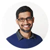 Sundar Pichai, wearing a blue sweater, smiles at the camera
