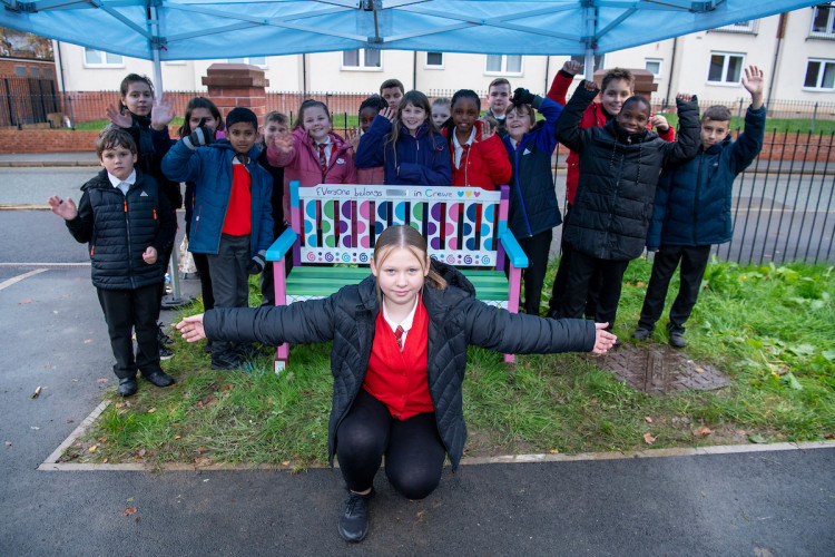 Olivia, 10, of Beechwood Primary School, in front of the new Co-op bench she designed at St Mary’s Caritas Centre, Delamere Street (Co-op).