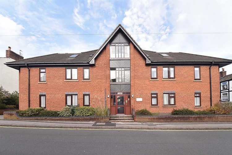 A Macclesfield flat in this building has gone up for sale for £69,950. (Image - Holden and Prescott)