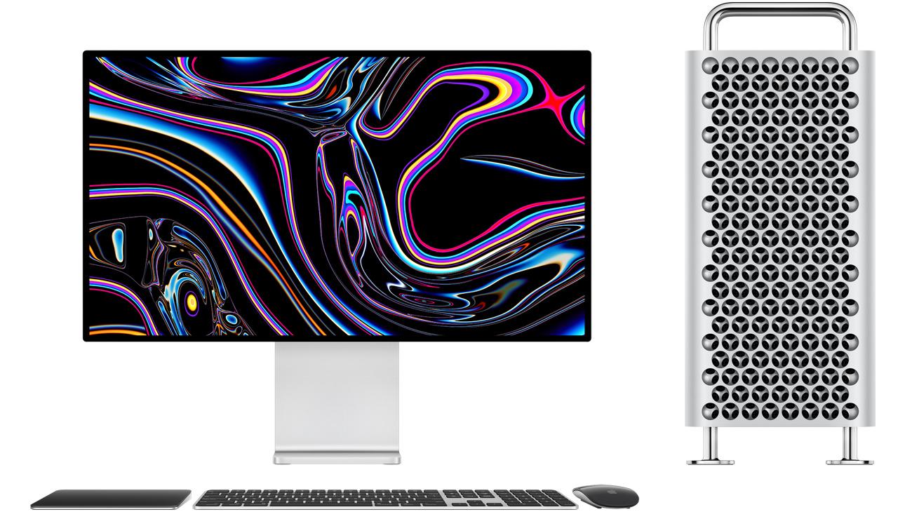 Mac Pro tower next to Pro Display XDR, black and silver Magic Trackpad, black and silver Magic Keyboard with Touch ID and Numeric Keypad, black and silver Magic Mouse