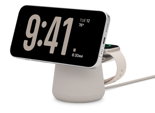 Belkin Boost Charge Pro 2-in-1 Wireless Charging Dock with MagSafe in Sand color simultaneously charging iPhone 15 Pro White Titanium finish and Apple Watch series 9, 41 mm case Starlight finish.