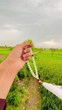 hand holding a garland of beads