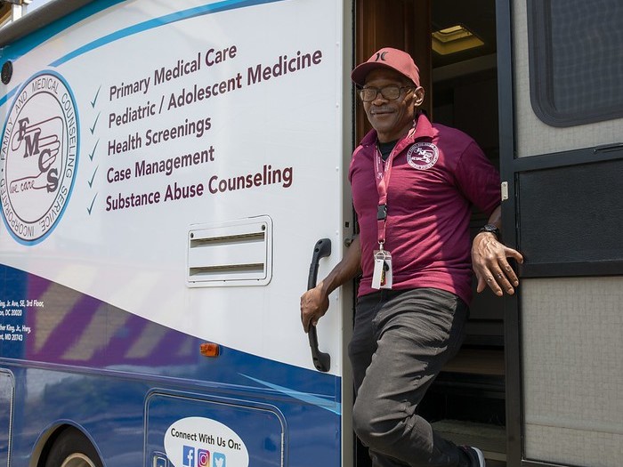 staff exiting a mobile van