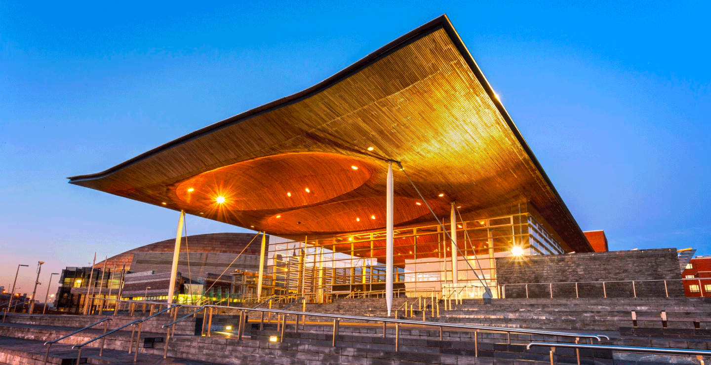 A nighttime shot of the Senedd in Cardiff Bay