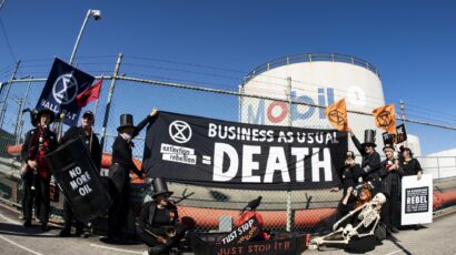 protest sign reads business as usual equals death