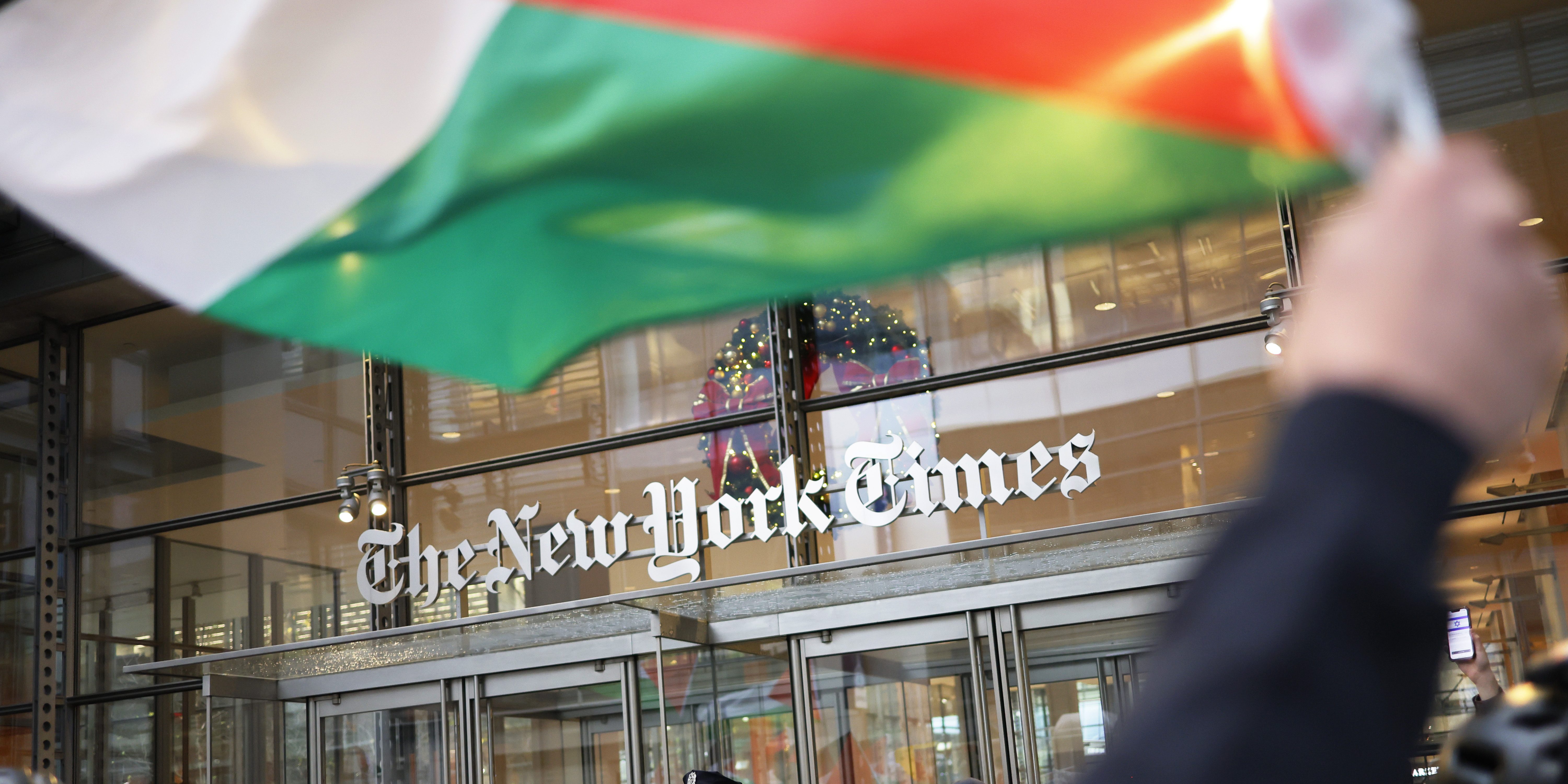 NEW YORK, NEW YORK - DECEMBER 18: NYPD officers guard the entrance to the New York Times as Pro-Palestine activists march as they participate in a Global Strike for Gaza on December 18, 2023 in New York City, New York. Activists gathered at Grand Central Station before marching as they continued to demand a ceasefire in Gaza. The protest convened just as the UN Security Council canceled an upcoming vote calling for a cessation of hostilities in Gaza as they try to change the language of the resolution to meet the US objections to the wording of the draft resolution saying they cannot support a “cessation of hostilities," but would agree to a call for a “suspension of hostilities." (Photo by Michael M. Santiago/Getty Images)