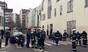 Police officers and firefighters gather in front of the offices of the French satirical newspaper Charlie Hebdo in Paris, after armed gunmen stormed the offices leaving 