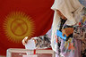 An ethnic Uzbek woman casts her ballot at a polling station in Osh, southern Kyrgyzstan, Sunday, June 27, 2010. Polls opened in violence-wracked Kyrgyzstan for a referendum Sunday to choose a new constitution that the interim government hopes will legitimize its power until new parliamentary elections in October. 