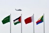 a helicopter flying over flags at the Ithra center during the 29th Summit of the Arab League in Dhahran in Eastern Province, Saudi Arabia on April 15, 2018.
