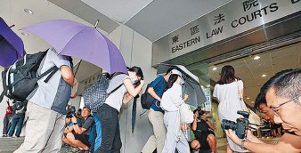 Activists accused of rioting head to a courtroom on Wednesday before being let off on bail. Some of those charged with the serious offense were as young as 16. Photo: HKEJ