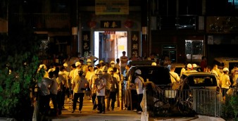 Men in white T-shirts with poles are seen in Yuen Long after a violent incident on July 21. Hong Kong’s anti-corruption watchdog is said to have begun a probe into the police conduct during that day. Photo: Reuters
