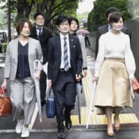 A group of lawyers representing a sex business operator walk to the Tokyo District Court on Wednesday, to sue the state over its blanket exclusion of the sex industry from a cash handout program amid the coronavirus pandemic.